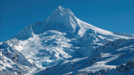 Majestic snow-capped mountain peak under a vibrant blue sky
