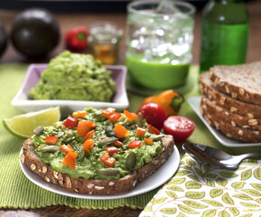 Delicious avocado toast with peppers and tomatoes, part of a refreshing brunch. Perfect for summer holiday and tropical vibes