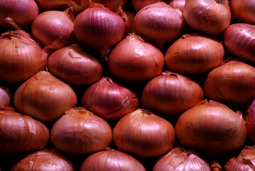 A vibrant display of red and yellow onions, perfect for restaurants, organic kitchens, and food market visuals.