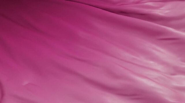 A closeup shot of draped pink fabric showing folds and creases