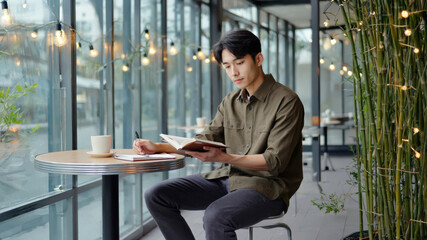 An Asian man sits comfortably at a café terrace during the afternoon, savoring coffee and reading a book. Surrounded by greenery and soft jazz, he enjoys a peaceful moment