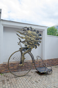 Novosibirsk, Russia 08.07.2025: sculpture cheerful sun on a bicycle