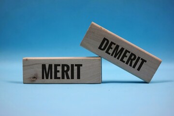 wooden block with "MERIT AND DEMERIT" written on it. Business and achievement concept. Isolated on a blue background.