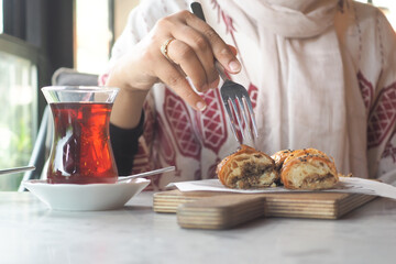 Women Enjoying tea and turkish borek 