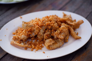 Crispy fried river fish in Thailand. Fried fish refers to any fish or shellfish that has been prepared by frying. Often, the fish is covered in batter, or flour, or herbs and spices before being fried
