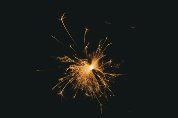 Burning sparks flying. Beautiful flames. Fiery orange glowing flying away particles on black background.	
