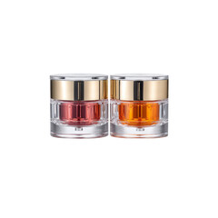 Two Luxury Cosmetic Jars with Gold Lids and Colorful Creams