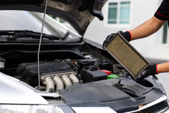 Auto mechanic holding car air conditioner filter for check and clean dirty or fix repair heat have engine problem or replace new change air filter of car care maintenance servicing concepts.