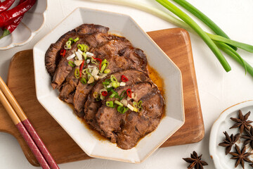Taiwanese braised beef shank slices in a plate on white table background.