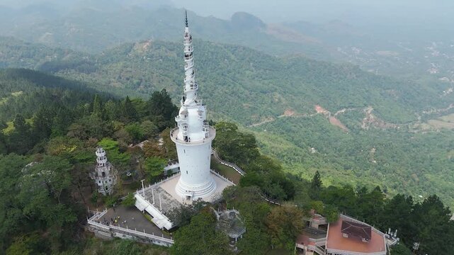 Aerial 4K drone footage of Ambuluwawa Tower, Sri Lanka. Stunning views of the iconic spiral tower, lush hills, and panoramic landscapes perfect for travel, cultural, and architectural projects.
