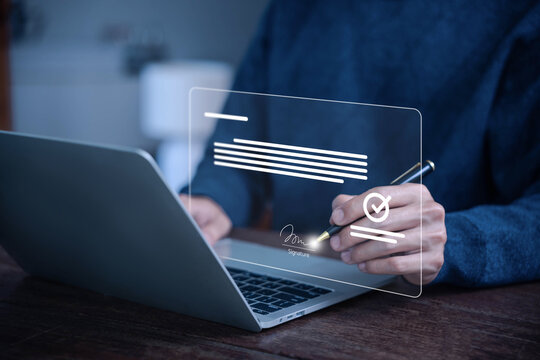 Man signing a digital document on a laptop using electronic signature technology, representing online contract approval, secure e-sign, paperless business agreement concepts. smart contract signature