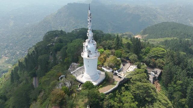 Aerial 4K drone footage of Ambuluwawa Tower, Sri Lanka. Stunning views of the iconic spiral tower, lush hills, and panoramic landscapes perfect for travel, cultural, and architectural projects.
