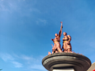 Bronze monument against a clear blue sky, symbolizing victory and aspiration