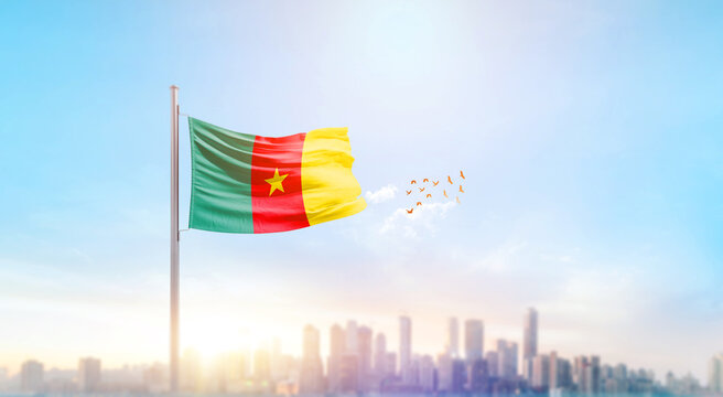 Cameroon national flag waving with skyline and buildings. A beautiful view of flag with skyline. - Powered by Adobe