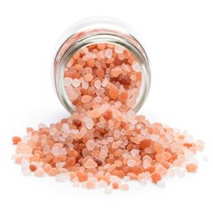 Pink himalayan salt spilling out of a glass jar isolated on white background