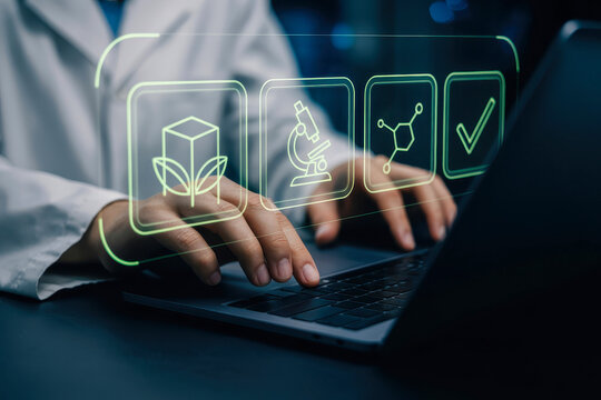 Biotech research scientist working on a laptop analysing data for science and technology innovation