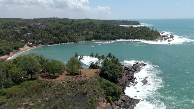 Aerial 4K drone footage of Matara Temple, Sri Lanka. Stunning coastal Buddhist temple with ocean views, lush greenery, and cultural heritage&mdash;perfect for travel, tourism, and spiritual projects.