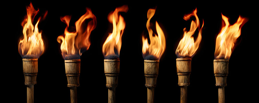 Five burning wooden torches with flames isolated on black background