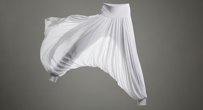 A pair of flowing white harem pants with a wide waistband, captured in a dynamic, mid-air pose against a minimal gray background, showcasing a graceful and artistic design.
