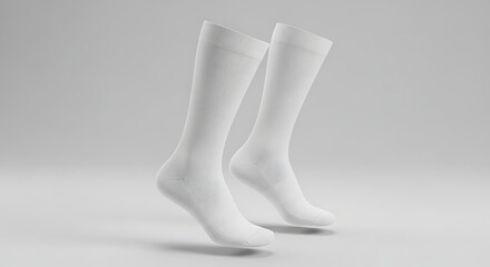 A pair of long, white dress socks, floating gracefully against a clean, light gray background, highlighting their sleek and simple design.