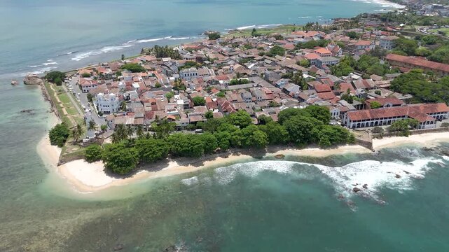 Aerial 4K drone footage of Galle Fort and coastline, Sri Lanka. Stunning views of historic Dutch Fort, lighthouse, beaches, and Indian Ocean&mdash;perfect for travel, tourism, and cultural projects
