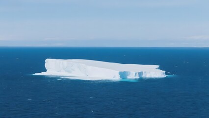 Massive Iceberg Floating in Calm Ocean Waters Under Clear Sky