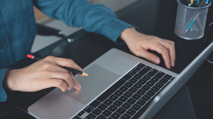 Close up, business woman using laptop computer searching the information, online working at home...