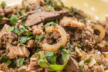 Close-up Northern Thai food: Pork Larb in an old-fashioned dish, (Larb Moo)