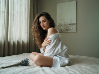 Intimate morning portrait woman white shirt bedroom natural light soft