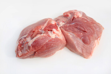 Raw pork meat pieces isolated on white studio background.