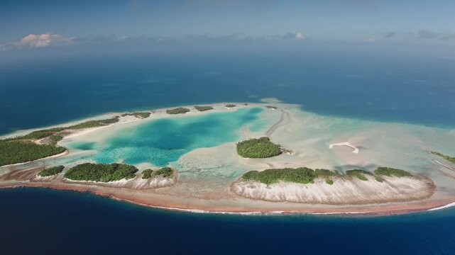 French Polynesia, Rangiroa island: Breathtaking aerial view showcasing Rangiroa atoll in French Polynesia. Highlighting vibrant turquoise lagoon waters. Lush vegetation. Drone flight footage