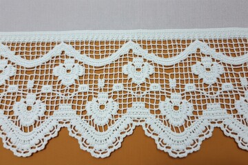 Intricate white crochet lace floral trim image