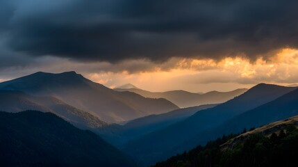 Mountain ranges at sunset with dramatic clouds.