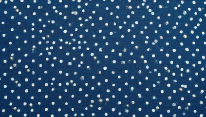 Indigo blue fabric with white polka dots and scattered speckles