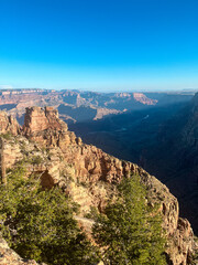Sunlit cliffs of the Grand Canyon rise above deep valleys under clear September skies.