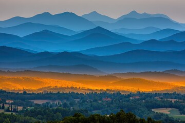 Fototapeta premium Layered mountain ranges in soft blues and golds