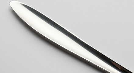 Closeup of a Shiny Reflective Metal Object on White Background.