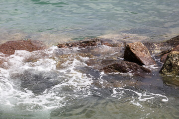 The water is calm and the rocks are scattered throughout the area
