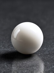 White sphere on dark surface