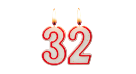 Two lit candles shaped as the number thirty two against a black background for a birthday cake