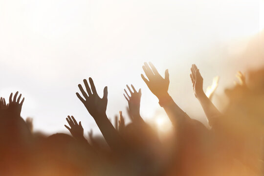 Christians passionately praising, praying, and worshipping, a background of a church gathering filled with the Holy Spirit, and a cheering crowd concept.
