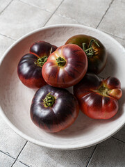 black prince tomatoes on a dark background
