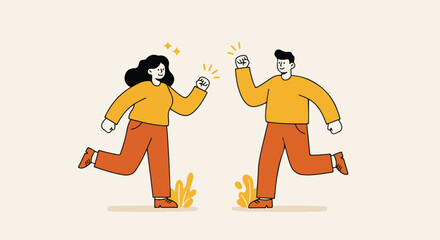 Joyful couple raising fists in the air, celebrating, wearing orange clothes on light background