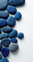 Indigo stones cascade down a white background