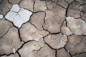 The ground has cracks in the top view for the background or graphic design with the concept of drought and death.