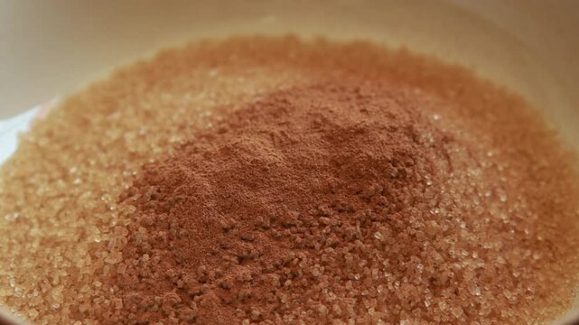 mixing brown sugar cinnamon and nutmeg in a bowl close up stock video