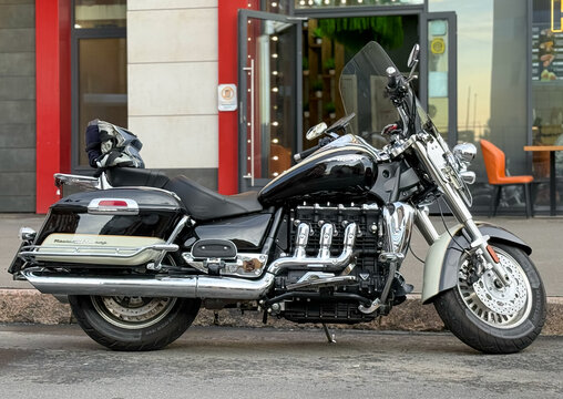 Bike Classic Triumph Rocket 3 TFC parked on the street. The Triumph Rocket III is a three-cylinder motorcycle made by Triumph Motorcycles Ltd. engine, motor.