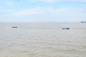 Two fishing boats crossed the waters of the Karimun Islands during the day.