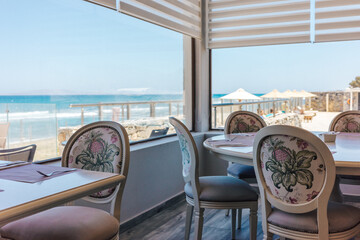 Elegant Beachfront Restaurant Interior with Scenic Ocean Views Through Large Windows