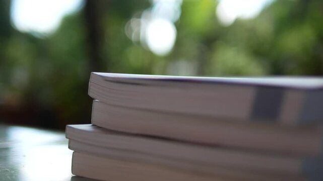 Stack of Books on Table with Blurred Background